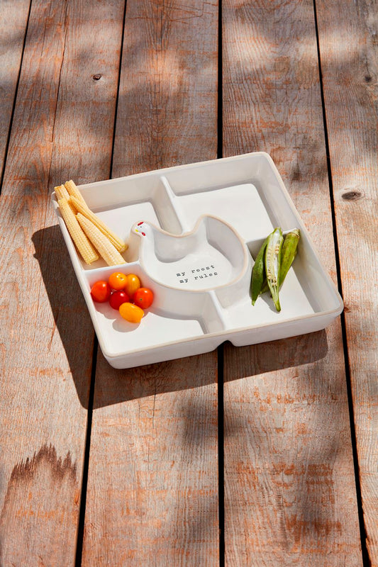 White divided plate with vegetables on a wooden surface