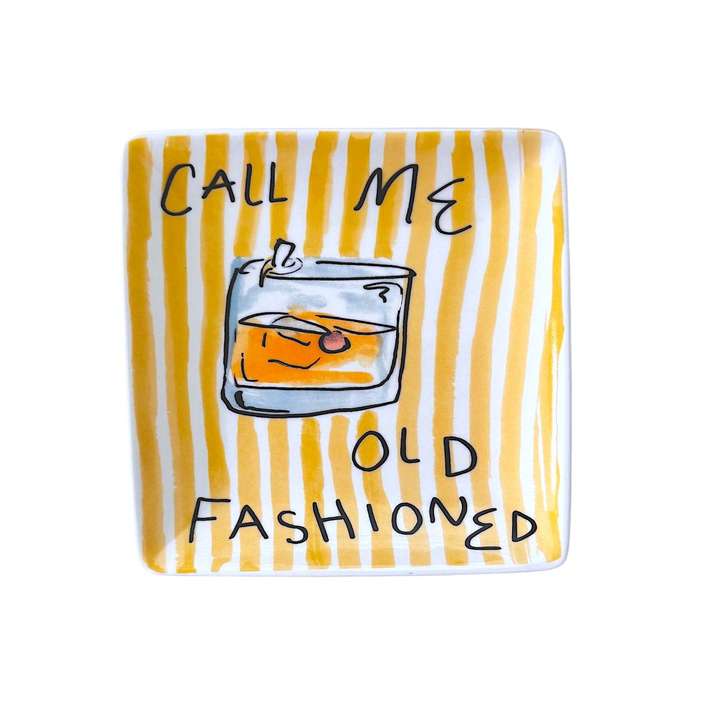 Decorative plate with a glass of whiskey and an orange slice, text 'Call Me Old Fashioned' on a yellow and white striped background.