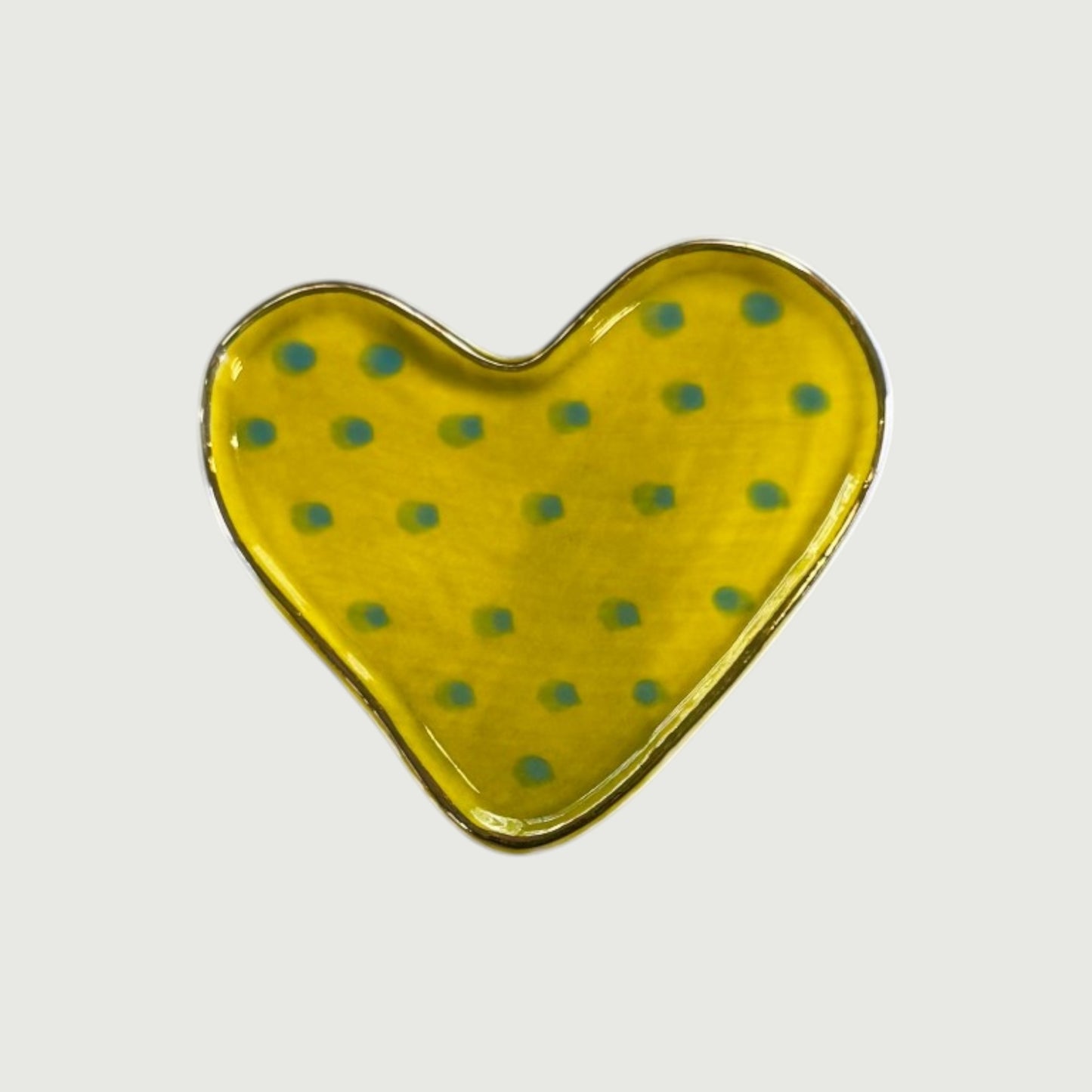 Heart-shaped yellow magnet with green polka dots