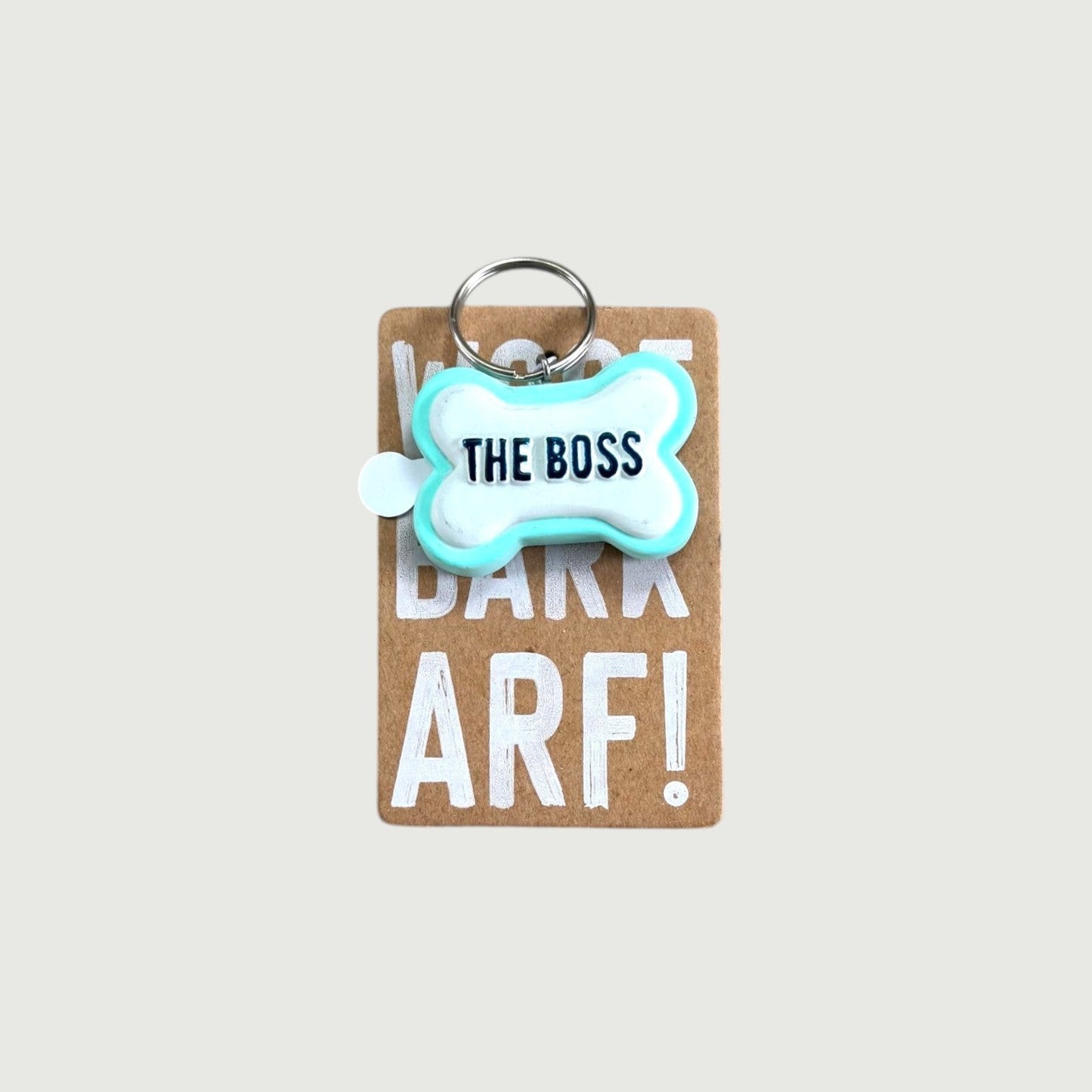 Keychain with 'The Boss' on a dog bone shape.