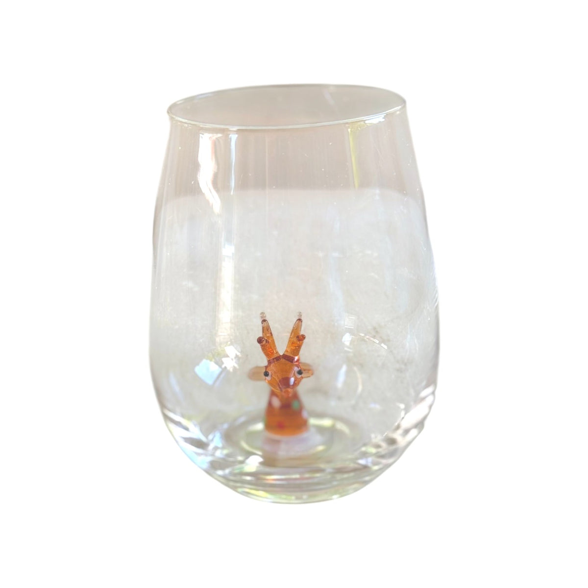 A clear stemless wine glass featuring a small orange and white deer figurine embedded in the base, set against a plain white background.
