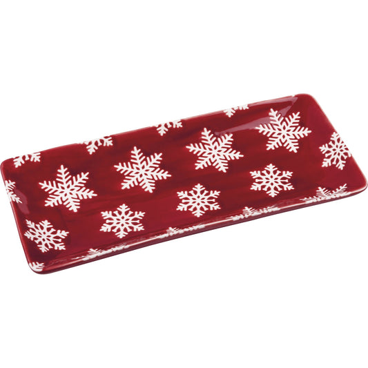 Red rectangular plate with white snowflake patterns on a white background