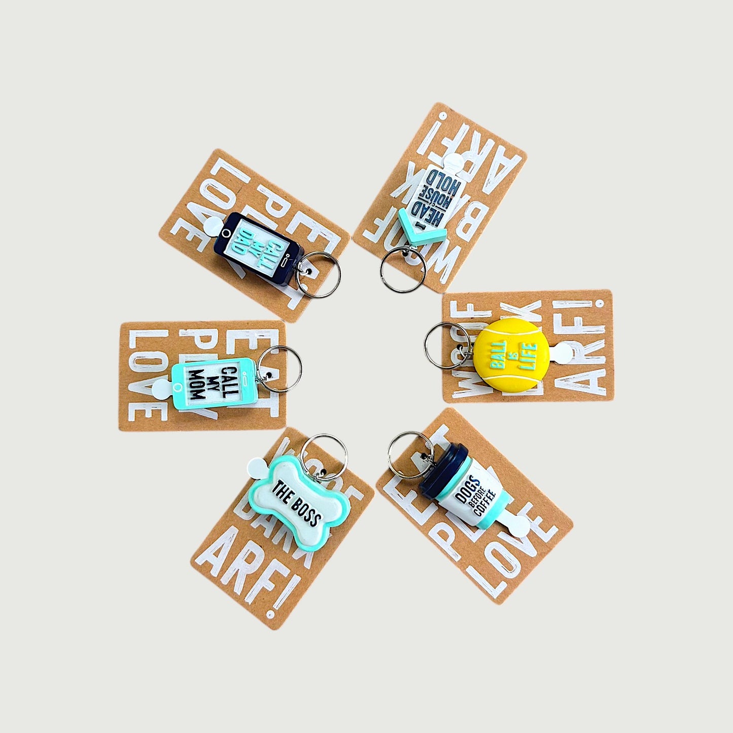 Set of keychains with humorous text on brown cards against a light background