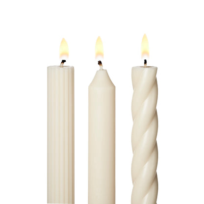 Three white candles with different textures