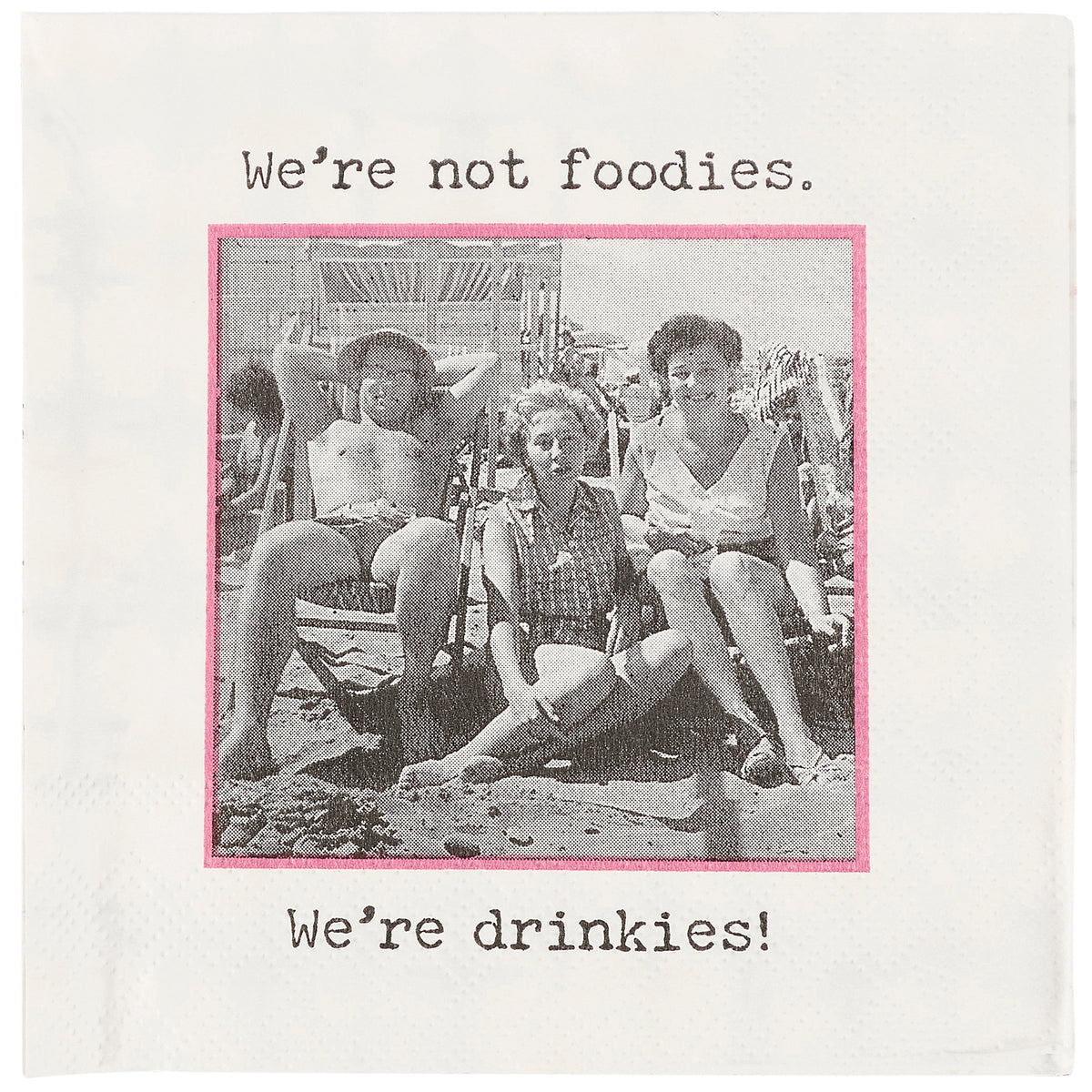 Vintage photo on a napkin of people at a beach with text 'We're not foodies. We're drinkies!' on a white background.