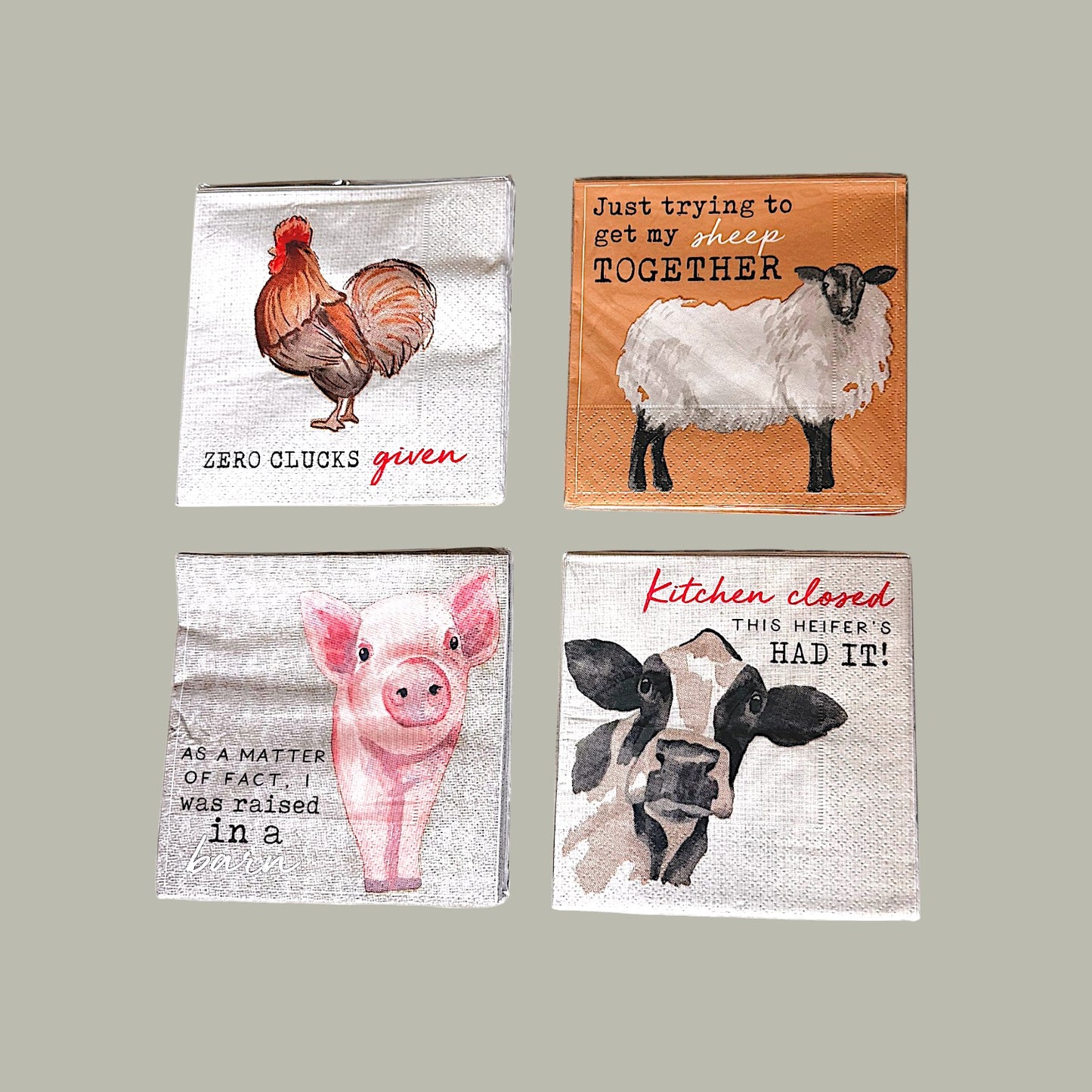 Four decorative napkins with animal illustrations and humorous text