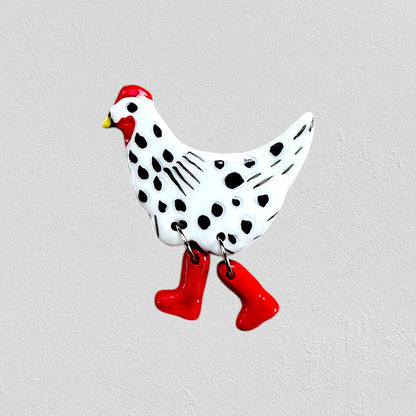 Decorative chicken figure with black spots and red rain boots 