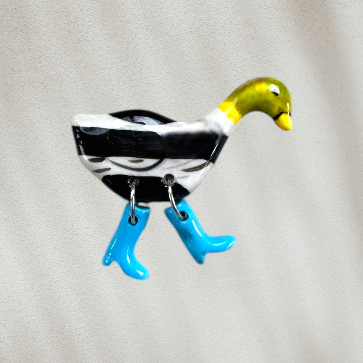 duck-shaped magnet with blue rain boots