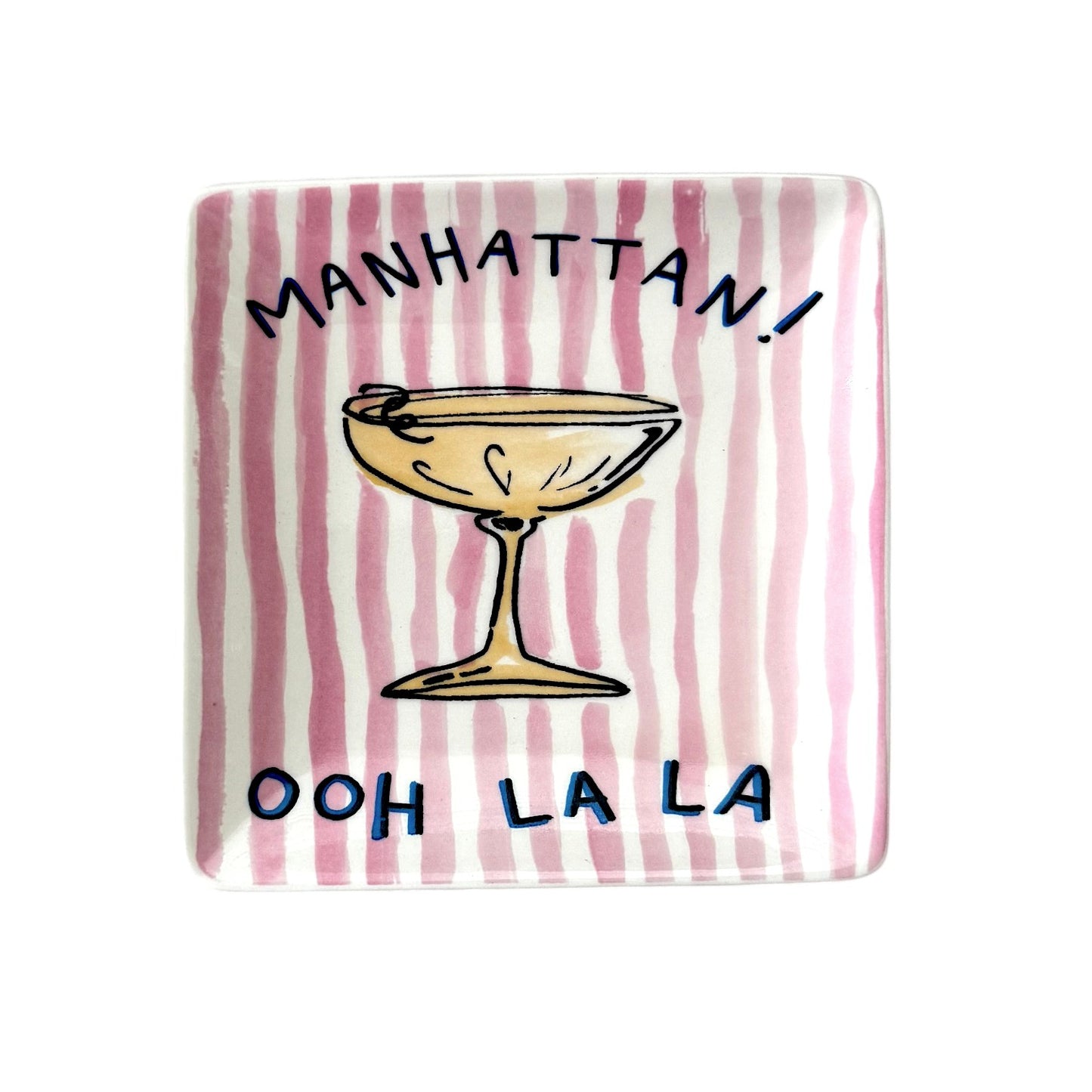 Rectangular plate with a striped pattern and text 'Manhattan! Ooh La La' on a pink 