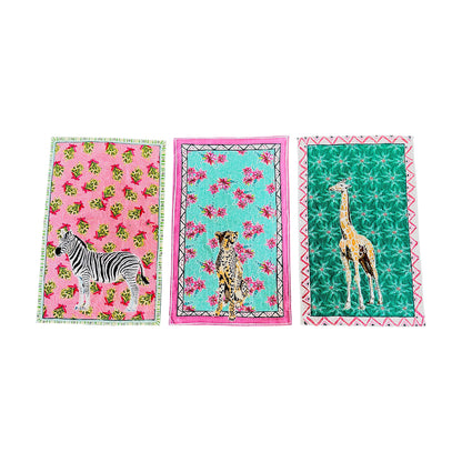 Three fabric towels with animal prints on a white background
