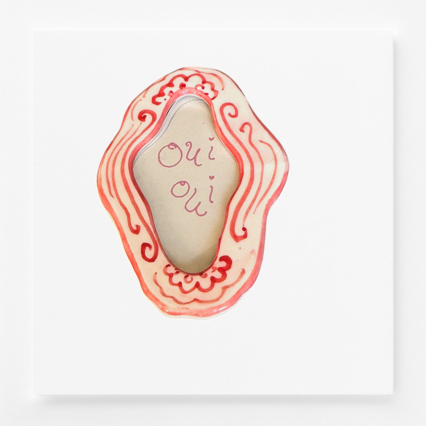 Decorative magnet frame with wavy design and 'Oui Oui' text 