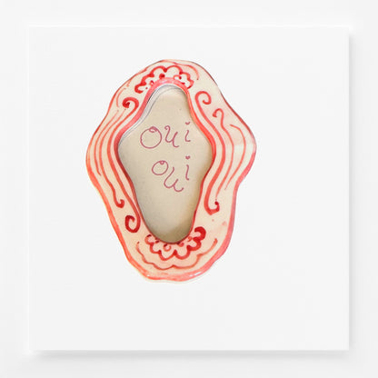 Decorative magnet frame with wavy design and 'Oui Oui' text 