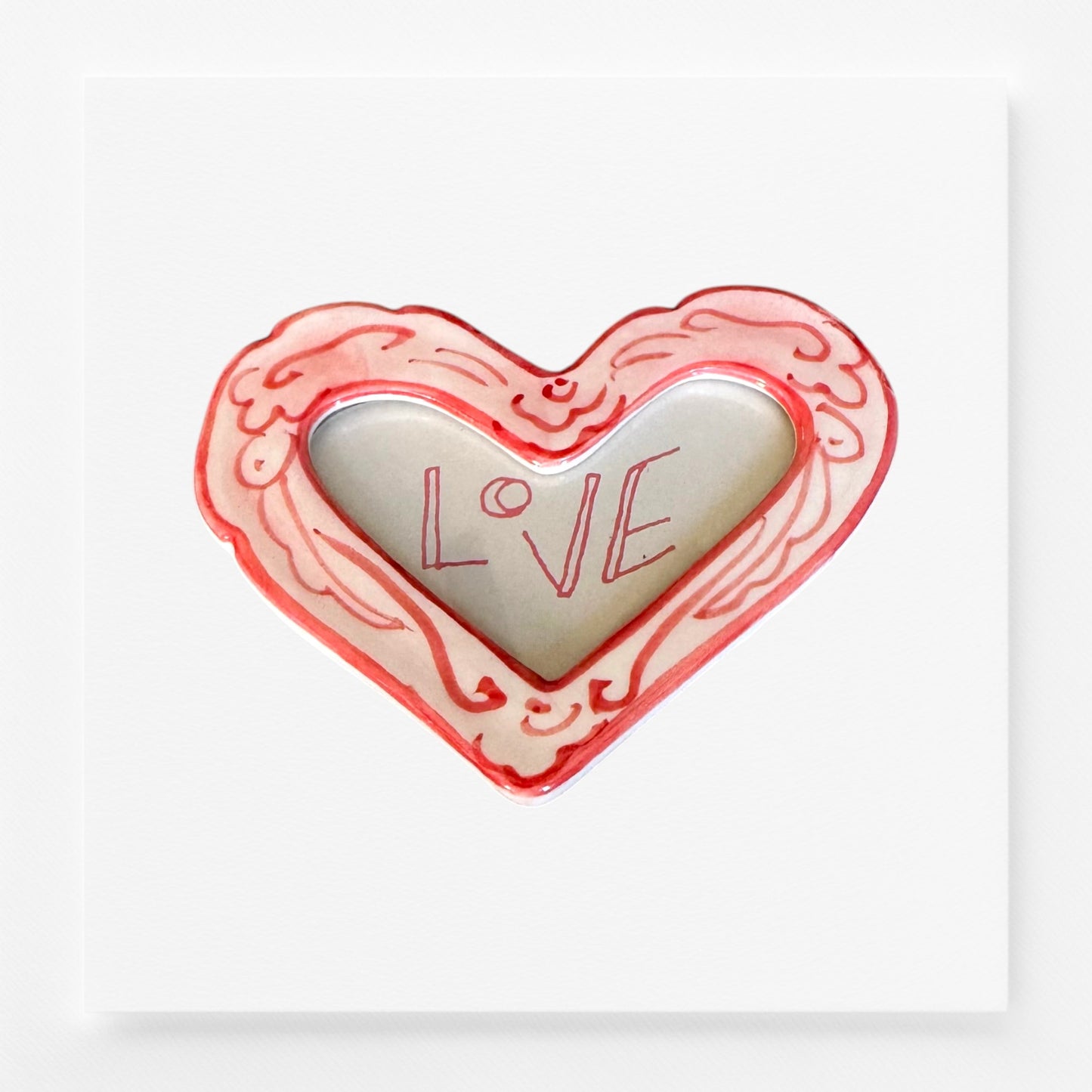 Heart-shaped frame magnet with 'LOVE' engraving