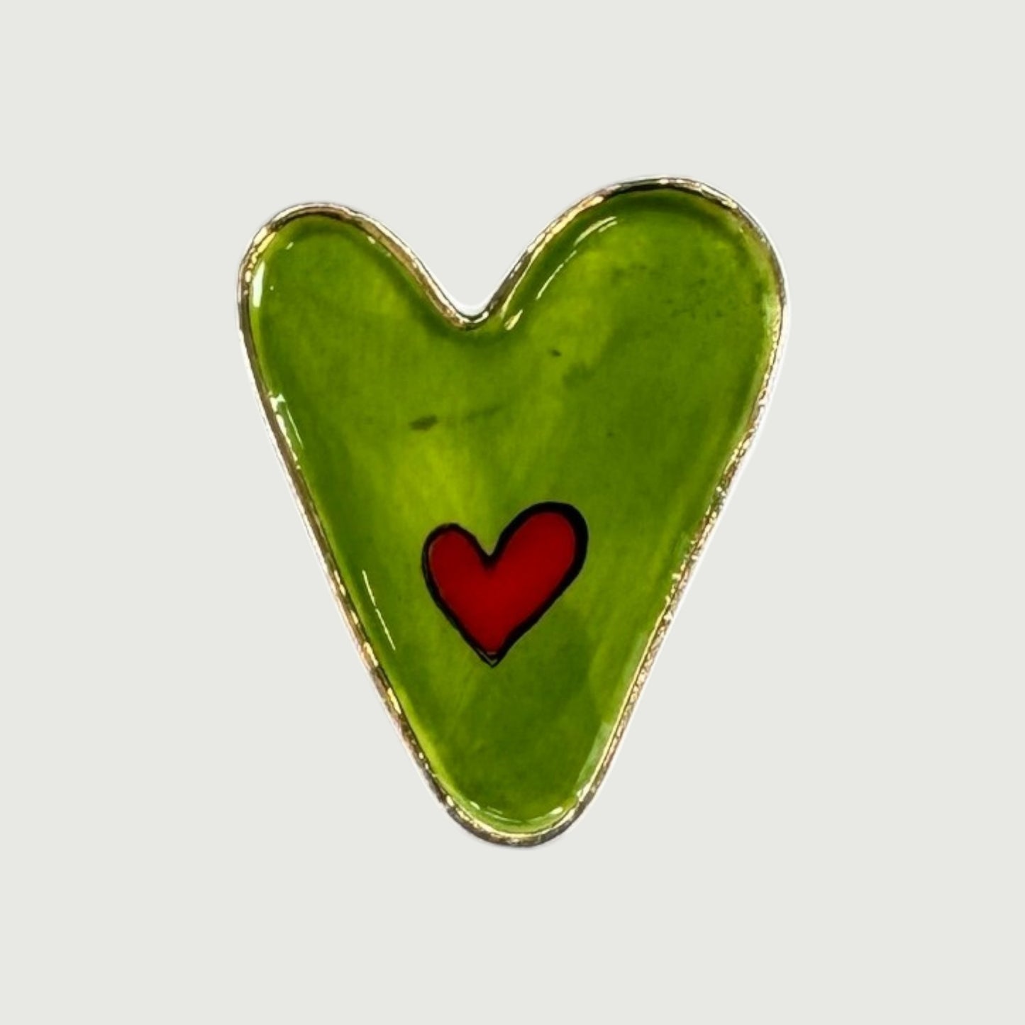 Green heart-shaped magnet with a red heart in the center 