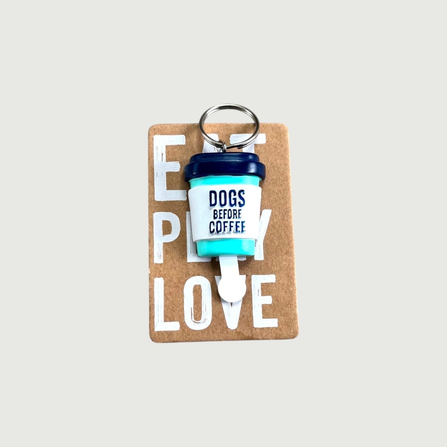 Keychain with 'Dogs Before Coffee' text 