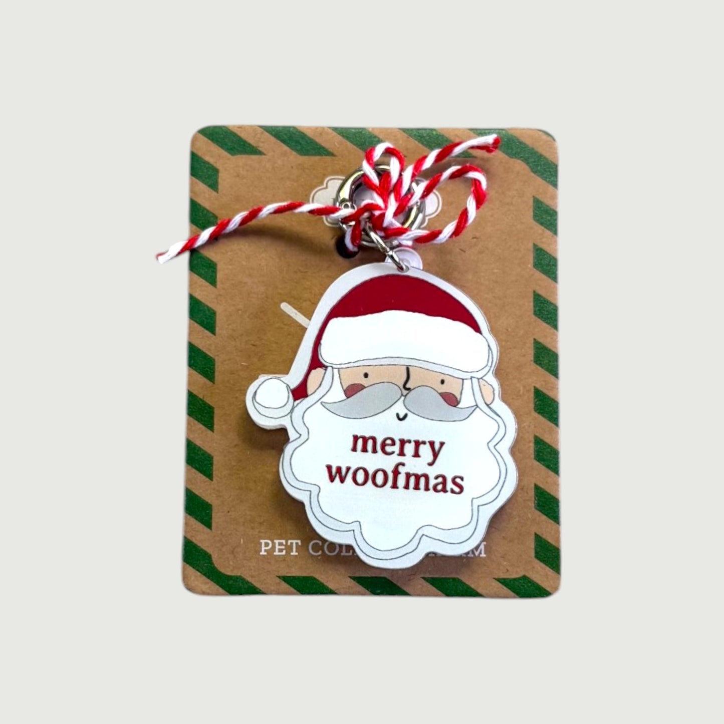 Dog collar tag with Santa Claus design and 'merry woofmas' text