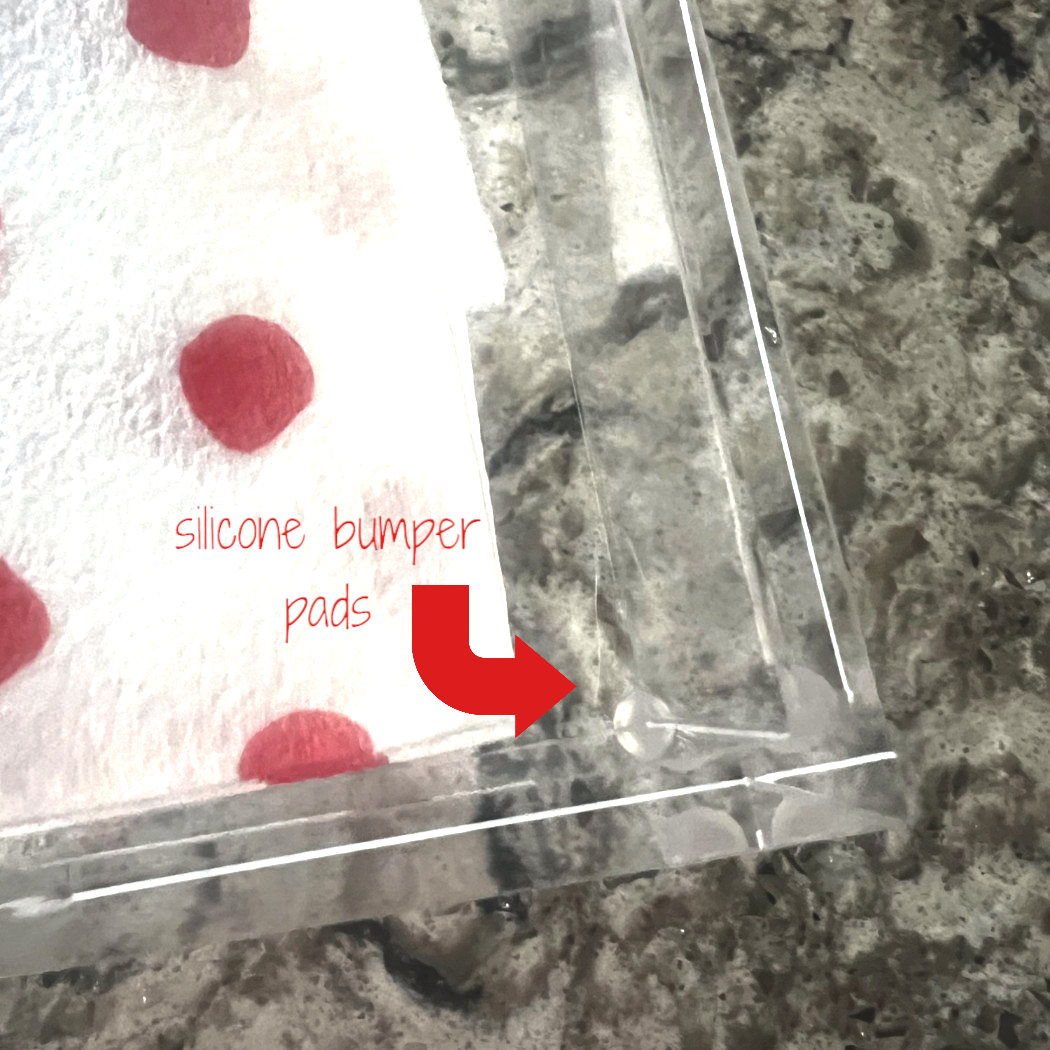 Clear silicone bumper pads on acrylic napkin holder