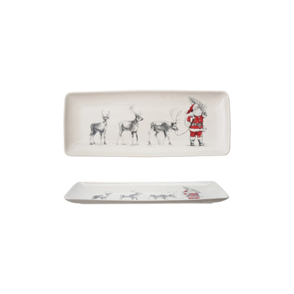 Two ceramic trays with Christmas-themed designs with Santa and reindeer