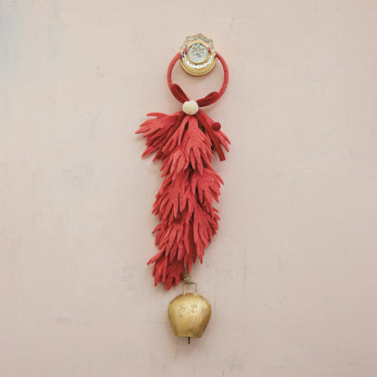 Decorative wall hanging with coral red tassel and gold bell 