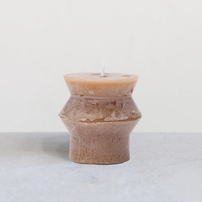 Light brown colored candle with sculptured design