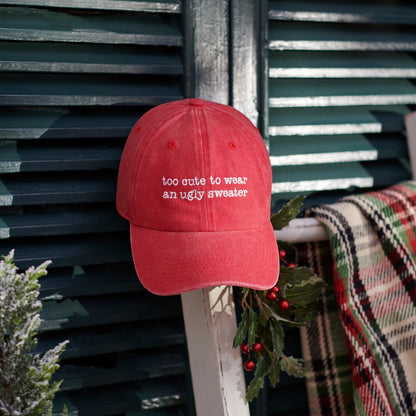 CJ Gift Goddess red washed cotton baseball cap with white embroidery reading "too cute to wear an ugly sweater".