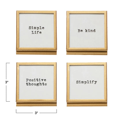 Four square gold metal frames with inspirational sayings