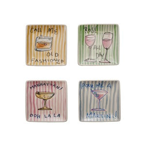 Four square ceramic plates with cocktail-themed designs and text 