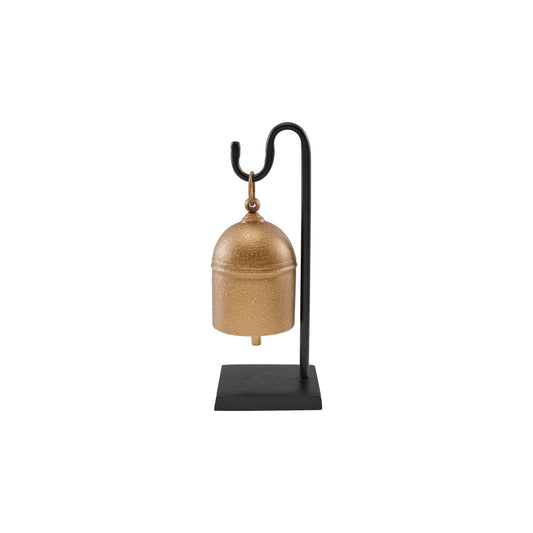 Decorative gold bell on a black stand against a white background